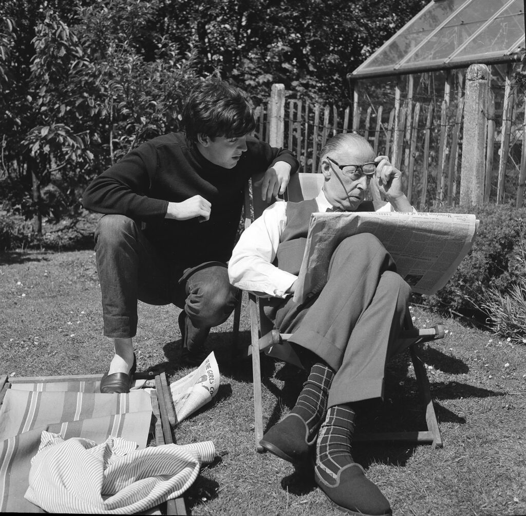 Paul (left) and Jim (right) McCartney working on a crossword in the garden of 20 Forthlin Road. Image © 2026 Mike McCartney.