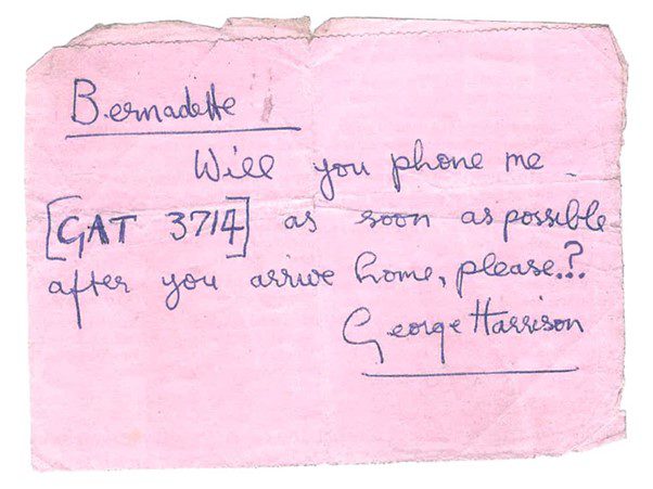 a note to bernadette from george harrison, on pink card, which reads: "bernadette, will you phone me [GAT 3714] as soon as possible after you arrive home, please?... george harrison"