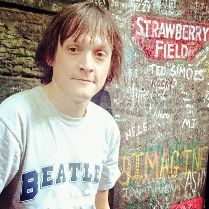 Ryan at the entrance to Strawberry Fields, Liverpool.
