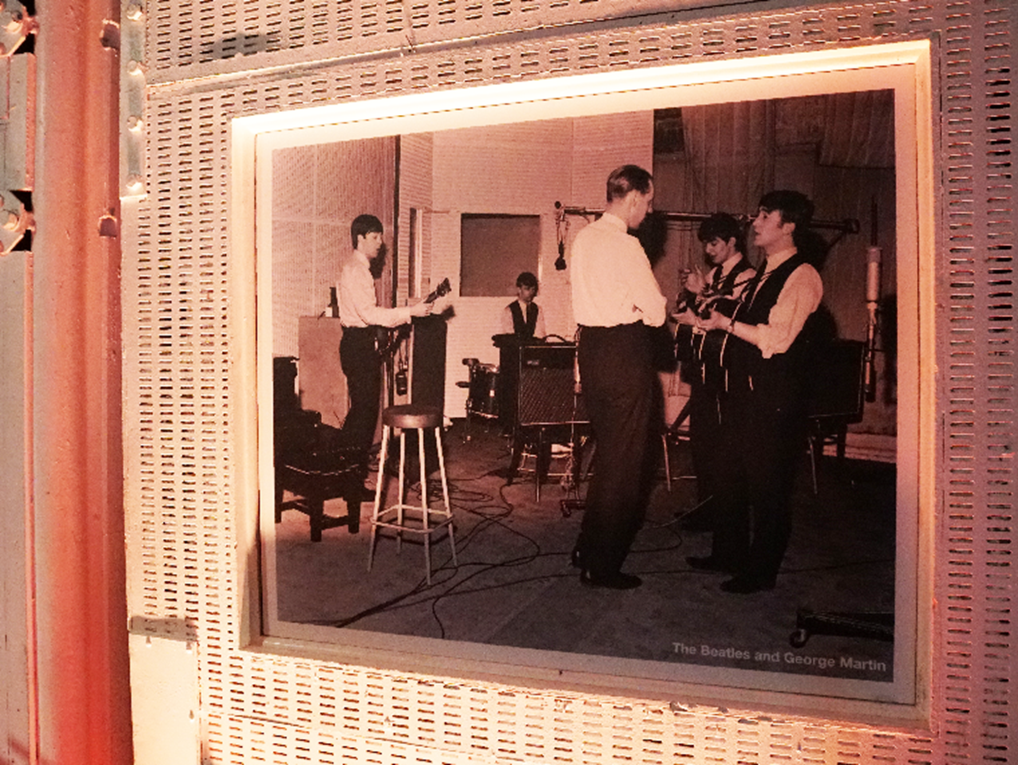 A photo of George Martin and The Beatles on display in Studio 2, Abbey Road Studios